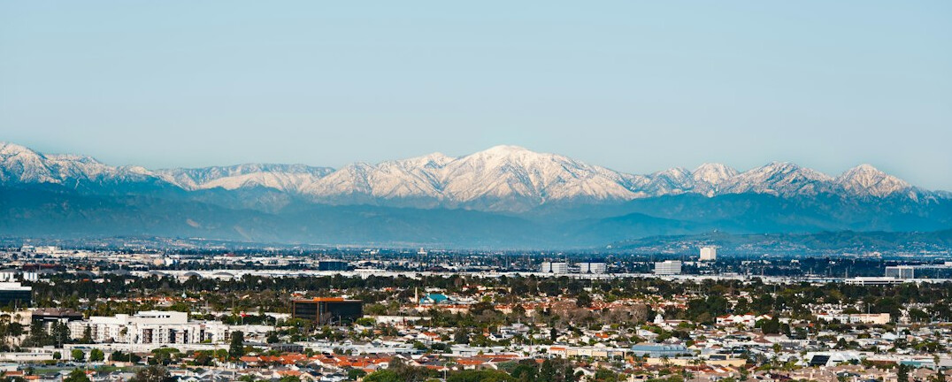 Mountain range skyline resembling the Andes behind a city