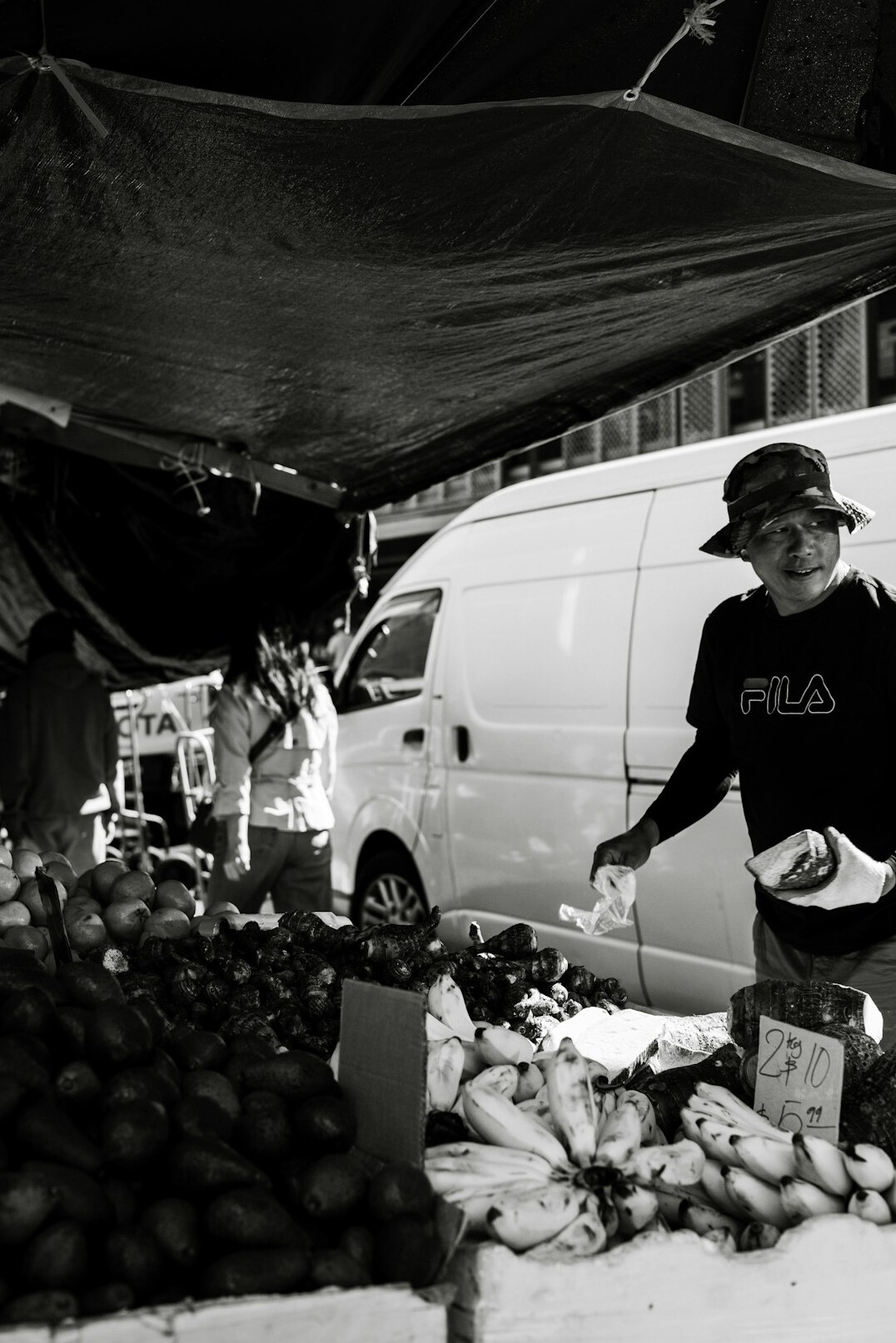 Chilean market vendor arranging fresh produce at a street stall